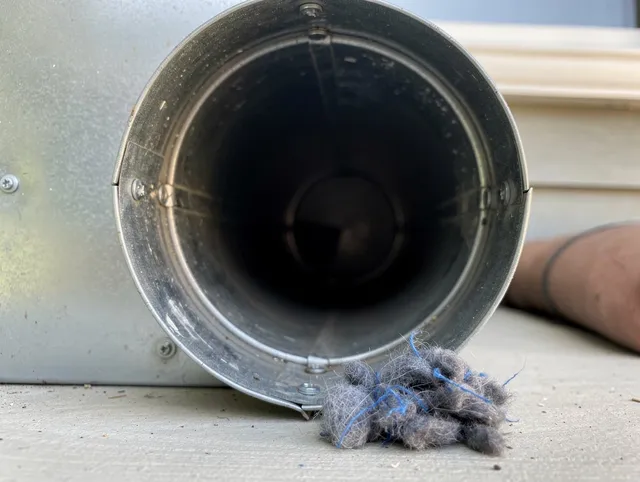 Cape Coral Dryer Vent Cleaning technician using specialized equipment to clear severe dryer vent blockage in Cape Coral